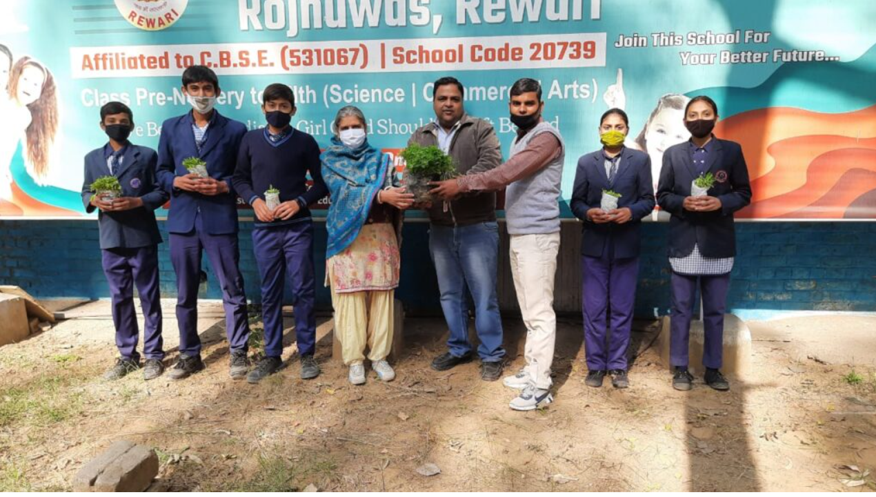 Students holding plants