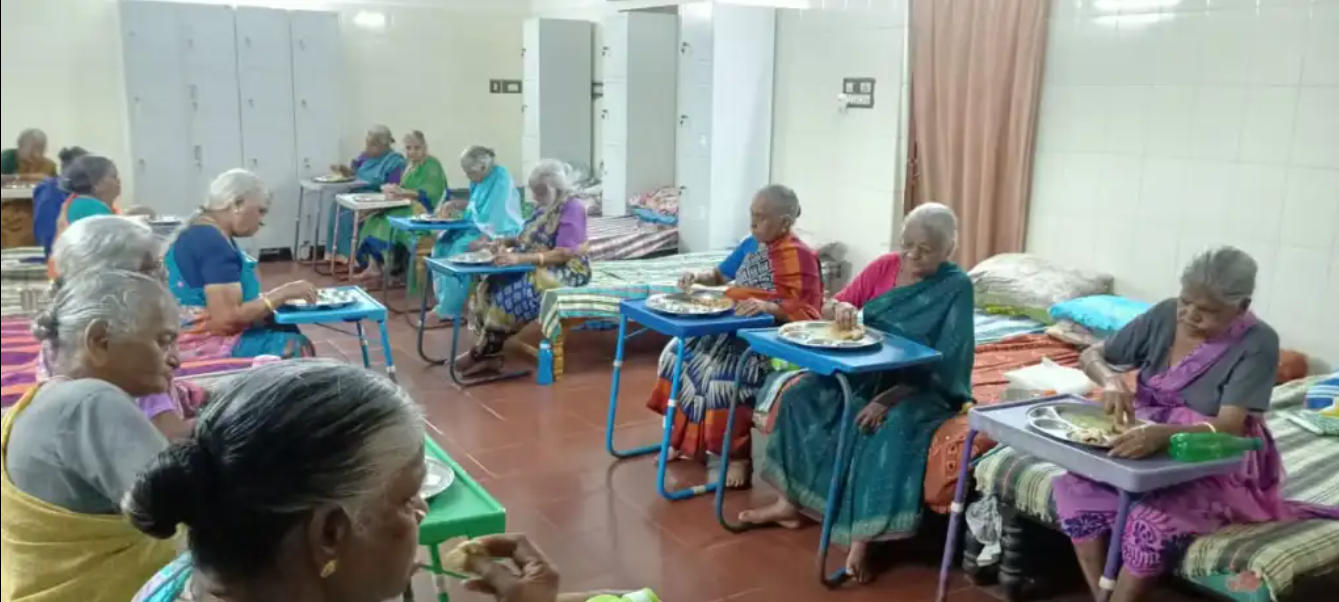 Volunteers serving elders in old age home